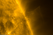 A solar prominence hovers over the Sun